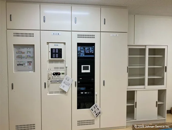 改修後の総合盤。新しい機器を収納した大型盤が設置され、操作部やモニターが整理された完成後の状態。